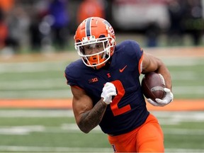Illinois running back Chase Brown carries the ball during the first half of an NCAA college football game against Purdue Saturday, Nov. 12, 2022, in Champaign, Ill.