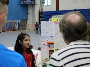 Vanshi Shah, 9, a fourth-grader at Sarnia's Rosedale elementary school, explains her Lambton County Science Fair entry, Wind Blowing –&ampgt; Energy Growing," to  judges Saturday morning at Lambton College's gym. "It's cool," Shah said of the experience. (Terry Bridge/Sarnia Observer)
