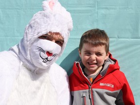 Ben Waite, 6, has his photo taken with the Easter bunny at Friday's Easter egg hunt in Petrolia's Greenwood Park.