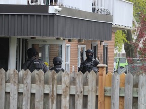 Sarnia police officers enter an apartment building at 125 Euphemia St. Tuesday morning.  Sarnia police issued a statement asking the public to avoid the area because of an “ongoing incident.”  (Paul Morden/The Observer)