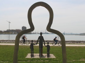 Cyclists pass the Victims of Chemical Valley memorial in Sarnia's Centennial Park.  (Picture file)
