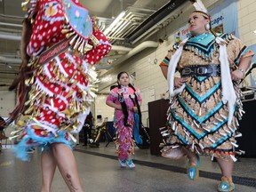 Dancers from Aamjiwnaang First Nation take part in Friday evening's National Day of Mourning ceremony held at Sarnia's Clifford Hansen Fire Station.  Paul Morden/The Observer