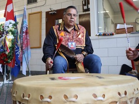 Darren Henry, a band councilor with Aamjiwnaang First Nation, joins other drummers taking part in Friday evening's National Day of Mourning ceremony held at Sarnia's Clifford Hansen Fire Station.  Paul Morden/The Observer
