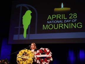 Keynote speaker Stephanie Proulx addresses an audience at the National Day of Mourning ceremony at Laurentian University in Sudbury, Ont. on Friday April 28, 2023.