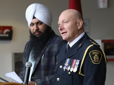 Greater Sudbury Police Chief Paul Pedersen makes a point as Karan Badhesha looks on at a ceremony marking Sikh Heritage Month at Tom Davies Square in Sudbury, Ont. on Monday April 3, 2023. The Nishan Sahib Sikh flag was raised during the ceremony. John Lappa/Sudbury Star/Postmedia Network