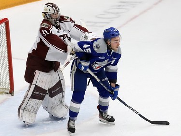 Goalie Michael Simpson, left, of the Peterborough Petes, pushes Ethan Larmand, of the Sudbury Wolves, from the crease during OHL playoff action at the Sudbury Community Arena in Sudbury, Ont. on Tuesday April 4, 2023. John Lappa/Sudbury Star/Postmedia Network