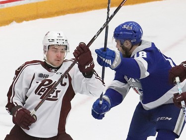 Nicholas Yearwood, right, of the Sudbury Wolves, and Shawn Spearing, of the Peterborough Petes, battle for position during OHL playoff action at the Sudbury Community Arena in Sudbury, Ont. on Wednesday April 5, 2023. John Lappa/Sudbury Star/Postmedia Network