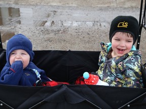 Alex Green, 1, left, and his brother, Zach, 3, share a ride in a wagon while going for a ride in Lively, Ont. on Monday April 10, 2023. John Lappa/Sudbury Star/Postmedia Network