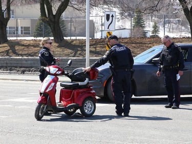 Greater Sudbury Police investigate a collision on Notre Dame Avenue involving a vehicle and a person on a scooter in Sudbury, Ont. on Wednesday April 12, 2023. The scooter operator was taken to hospital with non-life-threatening injuries. John Lappa/Sudbury Star/Postmedia Network
