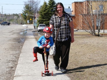 Stephanie Risk keeps a watchful eye on her son, Thomas, 3, while he rides his scooter in Lively, Ont. on Thursday April 13, 2023. John Lappa/Sudbury Star/Postmedia Network
