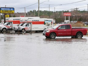 A parking lot is partially submerged on Notre Dame Avenue in Sudbury, Ont. on Monday April 17, 2023.