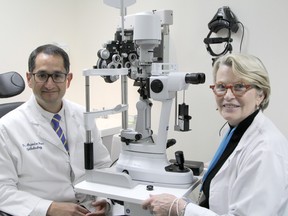Ophthalmologists Alejandro Oliver and Marie Louise Lapointe are seated at one of the phoropter /slit lamp eye examination devices in the newly opened locum ophthalmology clinic next to Timmins and District Hospital. Lapointe, who practices in Ottawa, is the inaugural locum for the clinic which had its formal opening on Friday.

RON GRECH/The Daily Press