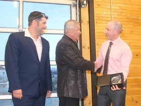 Ralph and Trevor Girard accept the award for 60 years of service to the community from Board of Trade president Frank Louvelle.
