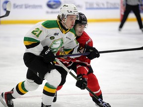 Ryan Humphrey (left) and Cedrick Guindon battle for position off the draw in the first period as the Owen Sound Attack host the London Knights in Game 3 of their Western Conference quarterfinal series at the Harry Lumley Bayshore Community Centre on Tuesday, April 4, 2023. Greg Cowan/The Sun Times