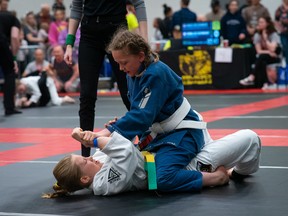 Kimberly Woodroffe (blue) mounting her opponent at the 2023 Budo Kids Open Brazilian Jiu-Jitsu tournament Saturday in Sudbury. Photo by Abrie Kilian