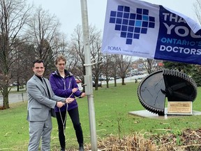 Mayor Matthew Shoemaker and orthopaedic surgeon Dr. Adrienne Kelly raise the Ontario Medical Association flag Monday at Ronald A. Irwin Civic Centre in recognition of Doctors’ Day. ELAINE DELLA-MATTIA/THE SAULT STAR