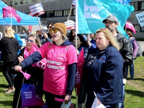 Unionized hospital workers from Kingston Health Sciences Centre and other workers from other parts of the province protest proposed privatization of hospitals at Breakwater Park across from Kingston General Hospital on King Street on Tuesday.