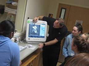 Students gather around a medical image display