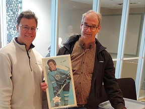 Stratford's Conroy Schelhaas and Hockey Hall of Fame resource centre and archives manager Craig Campbell show off a few of the posters from Schelhaas' complete 1971-1972 O-Pee-Chee NHL poster collection, which he recently donated to the Hockey Hall of Fame. Submitted photo