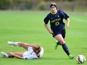 Jenna Hellstrom makes her way around a fallen opponent during action with the Kent State Golden Flashes women's soccer team.