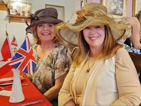 Patty Graham, left, and Dianne Denby were among the guests at Mrs. Bell’s Tea Room in downtown Chatham celebrating the coronation of King Charles III on Saturday. "It's a good excuse to pull our hats out of the closet," Denby said. (Trevor Terfloth/The Daily News)