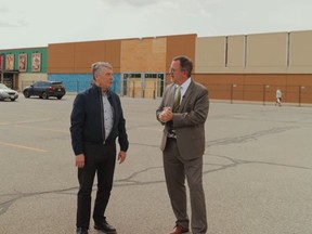 Dean Bradley, president of Brad-Lea Meadows, left, is shown with Mayor Darrin Canniff outside Thames-Lea Plaza in Chatham, where new stores were announced. (Facebook screengrab)