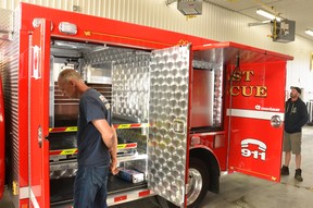 Perth East firefighters have a look through some of the features of their fire department's new rescue truck after it was delivered to the Perth East fire station in Sebringville Friday morning.  Galen Simmons/The Beacon Herald/Postmedia Network