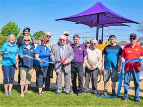 Chief park proponent and Trenton Lion’s Club chairman Michael Seymour, centre in purple shirt, was joined by Mayor Jim Harrison and other dignitaries at the park Saturday to officially open the first phase of the children’s play structure. DAVID LECLAIR