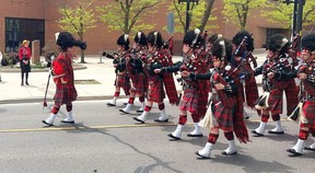 Lynn Cain enjoyed watching the pipe and drums of the Essex and Kent Scottish Regiment lead a military parade through downtown Chatham on Sunday. PHOTO Ellwood Shreve/Chatham Daily News