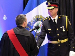 St. Thomas police Chief Marc Roskamp shakes hands with Ontario Court Justice Glen Donald at the change of command ceremony at the Joe Thornton Community Centre in St. Thomas on Tuesday, May 16, 2023. (Dale Carruthers/The London Free Press)