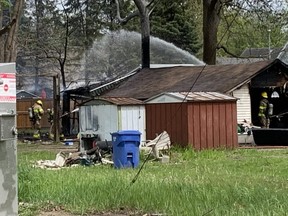 Firefighters from Stations No. 1 and No. 2 in Chatham battle a garage fire at Princess Street residence on Tuesday that also damaged a neighbour's fence. (Ellwood Shreve/Chatham Daily News)