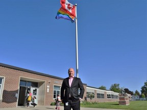 Dennis Wright, Thames Valley District school board superintendent of safe schools and wellbeing, stands in front of the Pride flag raised outside Emily Stowe elementary school in Norwich Township on Wednesday, May 17, 2023, to mark international day against homophobia, biphobia and transphobia.  (Calvi Leon/The London Free Press)