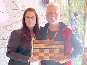 OVTA past-president Chris Hinsperger (right) presents Teresa Hebb of the Renfrew County ATV Club with the 2022 Tourism Champion Award.