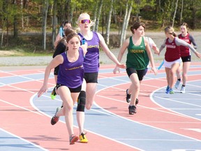 Participants in the girls 4x100-metre race make their way around the Laurentian Community Complex track during the SDSSAA track relays in Sudbury, Ontario on Wednesday, May 17, 2023.
