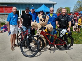 The donation of two e-bikes to the Saugeen Shores Police Service by the Rotary Club of Southampton will allow police access to remote areas of town. On hand for the presentation ceremony May 13 in Southampton were from left: Rotarian Tony Sheard, Brett Martin of Martin’s Bicycle Shop, Rotarians Stew Nutt and President Jenny Amy and Mike Roberts, Saugeen Shores Police Service Sgt. Andy Evans and Rotary mascot Bearama.