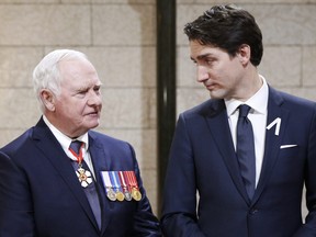 Canada's Governor General David Johnston (L) and Prime Minister Justin Trudeau speak in the Hall of Honor before the Speech from the Throne in Ottawa, Canada on December 4, 2015.