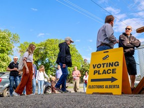 Calgarians in the Calgary-Mountain View riding line up to vote at Stanley Jones School on provincial election day, Monday, May 29, 2023.