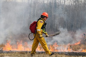 Firefighters with the Fort McMurray Fire Department conduct a controlled burn near Highway 63 on April 27, 2023. The controlled burns are part of the RMWB's FireSmart program, which is designed to fight and prevent fires and wildfires in the region. Vincent McDermott/Fort McMurray Today/Postmedia Network
