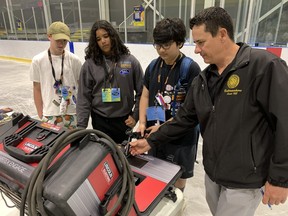St. Mary's students Jack McIntee, left, Gavin Persaud, and Ethan Chankasingh tried out a welding simulator set up by the International Brotherhood of Boilermakers, Local 128, at the first Epic Jobs event that's been held in four years.