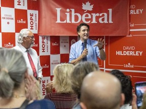 Prime Minister Justin Trudeau speaks to a packed crowd in the campaign office of Liberal candidate David Hilderley, left, in Woodstock on Thursday, May 25, 2023. A federal byelection will be held June 19. (Mike Hensen/The London Free Press)
