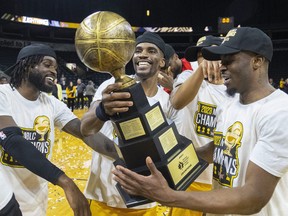 Marcus Ottey, Jeremiah Mordi and Mike Nuga of the London Lightning celebrate winning the National Basketball League of Canada title after beating the Windsor Express in the winner-take-all Game 5 at Budweiser Gardens in London on Friday May 26, 2023. Mike Hensen/The London Free Press