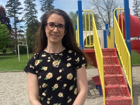 Parent council president Lara Rockefeller stands by the playground at Boston Public School where the most recent inspection by the Grand Erie District School Board showed the equipment will soon need to be replaced.