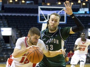 Kyle McConnell, left, of the Fanshawe Falcons drives past Mike Lucier of the Lambton Lions during their OCAA basketball game at Budweiser Gardens in London, Ont., on Sunday, Jan. 18, 2015. CRAIG GLOVER/The London Free Press/QMI Agency