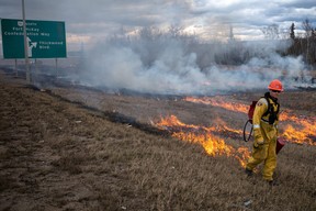 Firefighters with the Fort McMurray Fire Department conduct a controlled burn near Highway 63 on April 27, 2023. The controlled burns are part of the RMWB's FireSmart program, which is designed to fight and prevent fires and wildfires in the region. Vincent McDermott/Fort McMurray Today/Postmedia Network