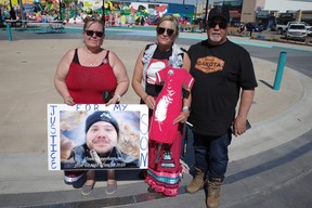 Judy Cheecham holds a photo of her late son, Joshua, with family at Kiyam Community Park for Red Dress Day events at Kiyam Community Park on May 5, 2023. Vincent McDermott/Fort Mcmurray Today/Postmedia Network