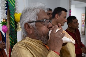 A man blows a conch shell called a shankha during Murti Pran Pratishtha, which are the opening ceremonies of a Hindu temple, at the Sanatan Mandir Cultural Society in Fort McMurray on May 22, 2023. The temple is Canada's most northern Hindu temple. Vincent McDermott/Fort McMurray Today/Postmedia Network