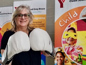 Shelley Rivard, CEO of Parkinson Society Southwestern Ontario, pulled on the gloves at the Owen Sound Y Wednesday to promote the Rock Steady Boxing program for people with Parkinson's, held twice a week there. (Scott Dunn/The Sun Times/Postmedia Network)