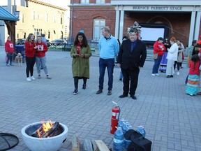 Chief R. Donald Maracle of the Mohawks of the Bay of Quinte chats with Bay of Quinte MP Ryan Williams shortly after they both threw ceremonial tobacco pounches on the small bonfire at Friday evening's vigil for Murdered or Missing Indigenous women in Market Square. JACK EVANS PHOTO