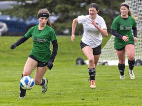 Rachel Guddemi (left) of the St. John's Eagles looks to pass the ball upfield during an AABHN high school girls soccer game against the Paris Panthers on Monday May 1, 2023 at the Green Lane Sports Complex in Paris, Ontario. Brian Thompson/Brantford Expositor/Postmedia Network