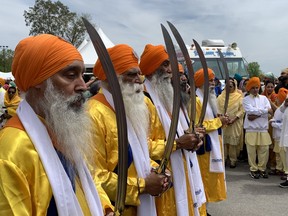 Ceremonial sword-bearing Sikhs in brilliant yellow were part of a parade of several thousand people celebrating Khalsa Day and marching through the streets neighboring the Brantford Sikh temple on Park Road North Sunday (May 14) afternoon.  SUSAN GAMBLE/BRANTFORD EXPOSITOR